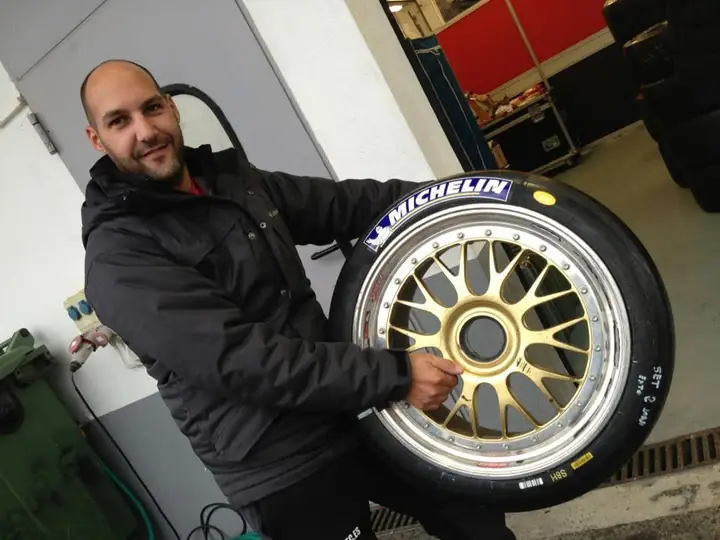 Juan con una rueda de competición Michelin en un box